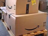 boxes stacked on a pallet in a warehouse with a smile drawn on them