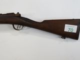 a rifle that is on display on a table