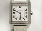 a silver watch with a white face on a white background