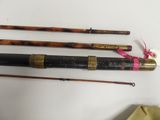 several different types of fishing rods are lined up on a table