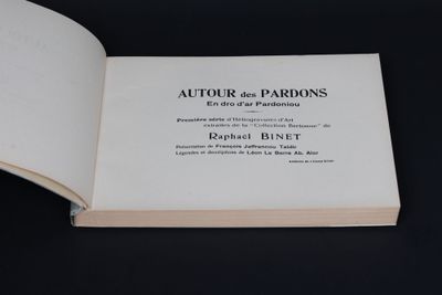 an open book on a black table with a black background