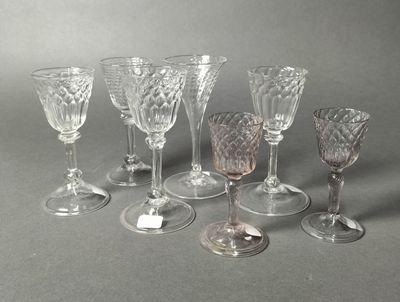 several wine glasses are lined up in a row on a gray surface