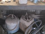 two propane gas cylinders sitting on a table