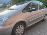 a silver car that is parked on the side of the road