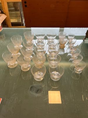 a lot of empty wine glasses on a glass table