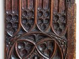 an old wooden panel with a design on it on a wall