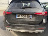 a mercedes car parked in a parking lot with other cars