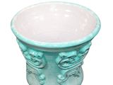 a green vase with a design on it