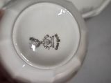 a close up of a white plate with a bird on it