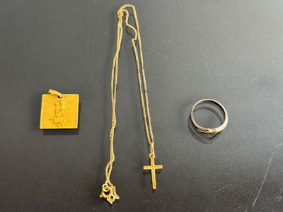 a close up of a necklace and a ring on a table