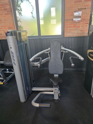 a gym equipment set up in a room with a brick wall