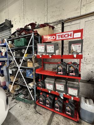 une voiture garée dans un garage, à côté d'une étagère remplie d'outils