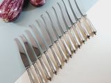 six knives and a knife holder on a table