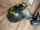 a vacuum that is sitting on the floor next to a wall