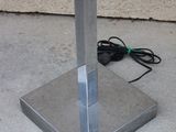 a metal stand with a clock on top of it