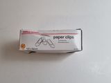 a box of paper clips sitting on a table