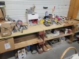 a workbench with a lot of clutter and tools on it