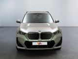 the front of a silver bmw x2 parked in a room
