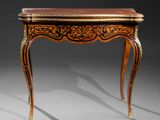 a small table with a wooden top and ornate carvings