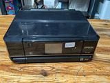 the printer is sitting on top of the wooden table in the room