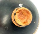 a black and gold vase with a hole in the top