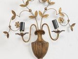 a wall mounted candle holder with two candles on it