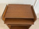 a small wooden table with two shelves on it
