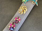 une broche violette et verte et une broche verte et violette