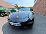 a black porsche parked on the side of the road