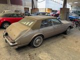 an old car is parked in a garage with other cars