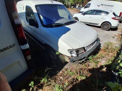 a white van that is sitting in the grass next to a white van