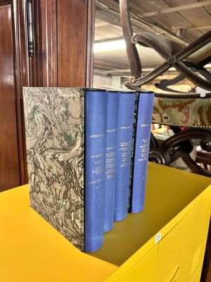 three books sitting on top of a yellow table
