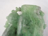 a green sculpture of a man and a woman on a horse