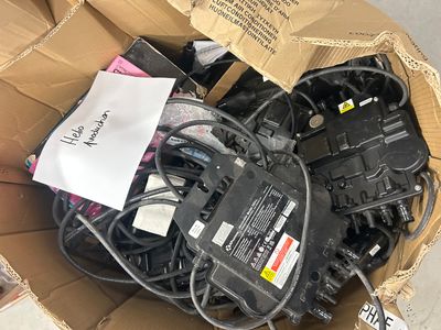 a cardboard box filled with assorted electrical equipment