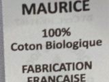 the label of a bottle of liquid on a white table