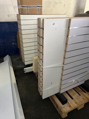une rangée d'armoires blanches dans une pièce remplie de palettes