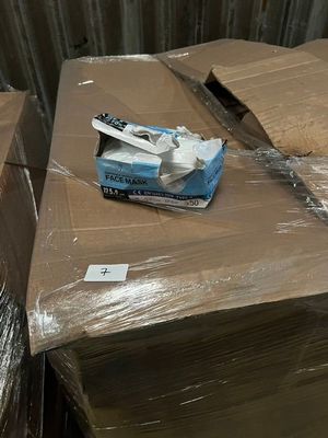 a box of toothbrushes sitting on top of a pile of boxes