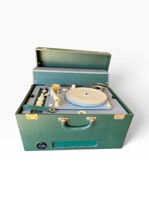 a green suitcase with a record player inside of it