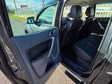 the open door of a car with the driver ' s seat down
