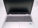 an open laptop computer sitting on top of a white table