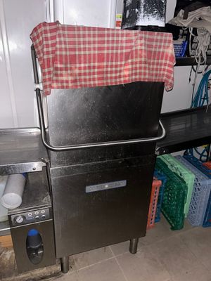 an image of a kitchen area with a sink and a refrigerator
