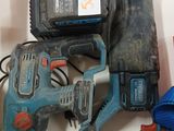 two electric tools that are sitting on a table