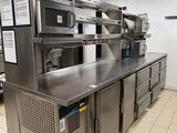 a large kitchen with stainless steel counter tops and appliances