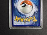 the pokemon trading card is in a plastic holder on a table