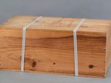 a wooden box with a white ribbon around it