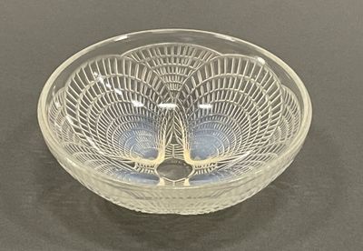 a glass bowl with a design on it on a table