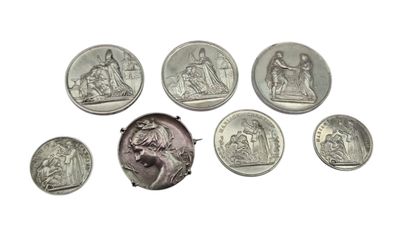 an image of a group of silver coins sitting on top of a white surface