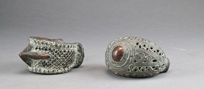 pair of silver and brown ceramic fish sculptures on a gray surface