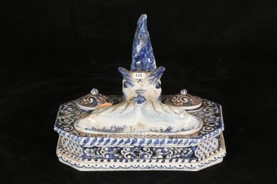 a blue and white figurine with a hat on top of it