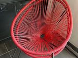 a red chair that is sitting in a kitchen